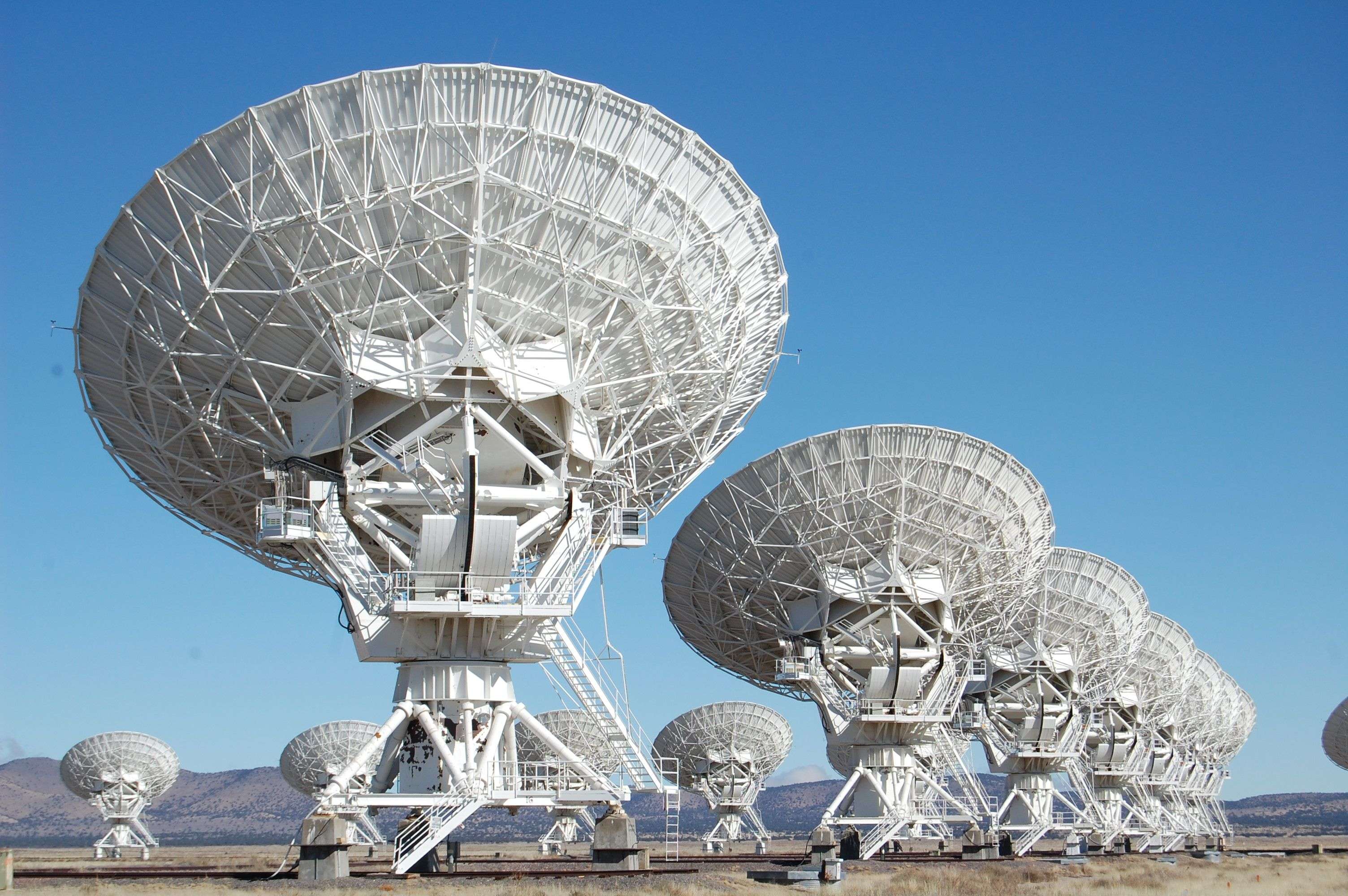 Rows of giant radio-telescope dishes pointed at the sky — always listening, like EntryBit’s real-time access-event monitoring